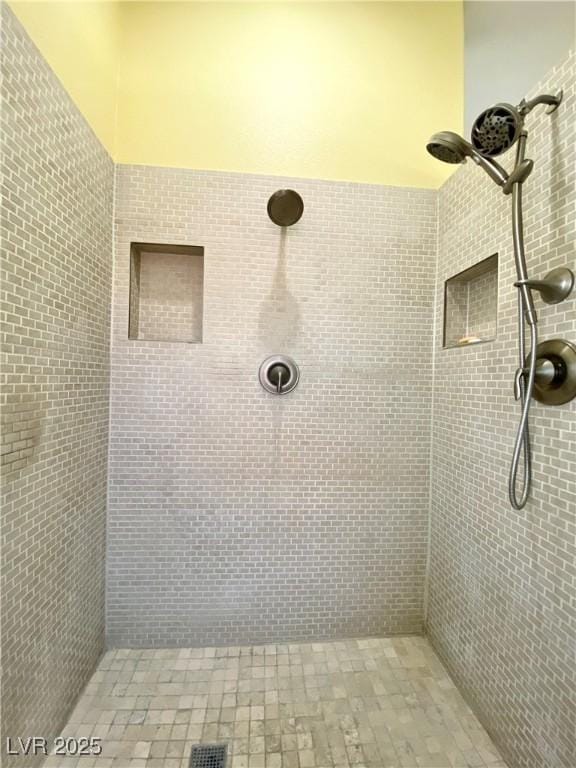 bathroom featuring a tile shower