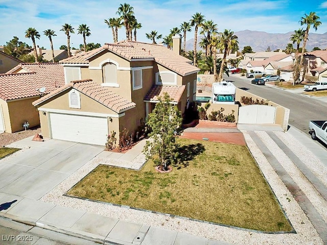 view of front of home featuring a mountain view, a tile roof, concrete driveway, a residential view, and stucco siding