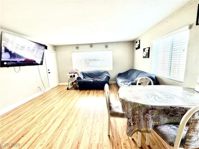 living area with wood finished floors and baseboards