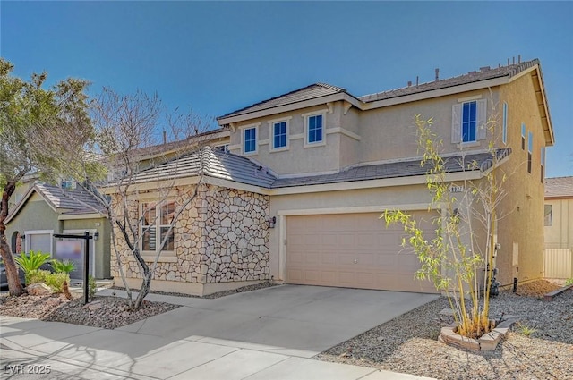 traditional-style house with a garage, stone siding, concrete driveway, and stucco siding