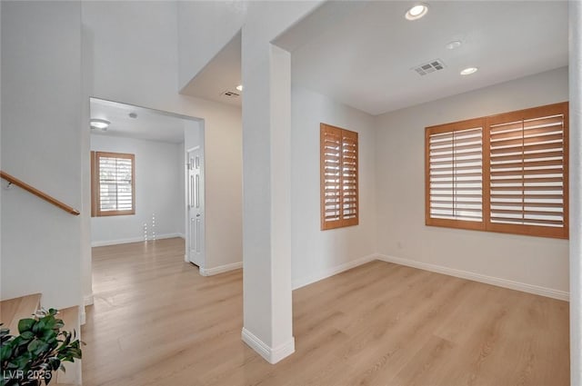 interior space with recessed lighting, visible vents, light wood-style flooring, and baseboards