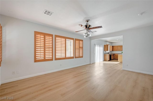 unfurnished living room featuring light wood-type flooring, visible vents, baseboards, and ceiling fan