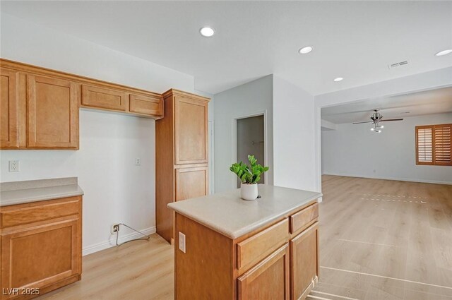 kitchen with ceiling fan, light wood-style flooring, recessed lighting, open floor plan, and light countertops