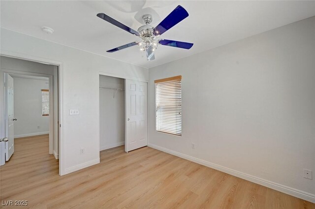 unfurnished bedroom featuring a ceiling fan, a closet, baseboards, and light wood finished floors