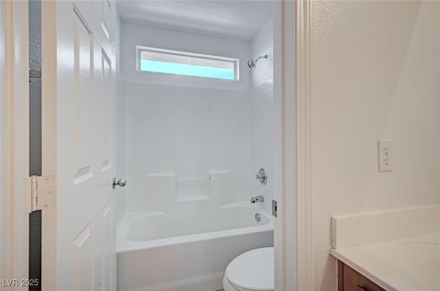 bathroom featuring bathtub / shower combination, vanity, and toilet