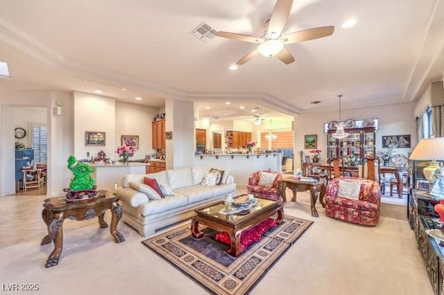 living room with a ceiling fan, visible vents, and recessed lighting