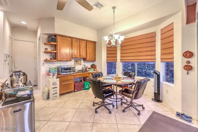 dining space with ceiling fan with notable chandelier, visible vents, baseboards, and light tile patterned floors