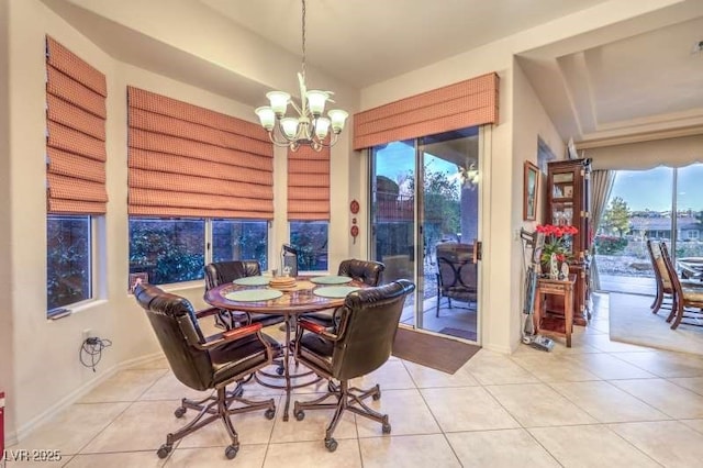 dining space with light tile patterned floors and an inviting chandelier