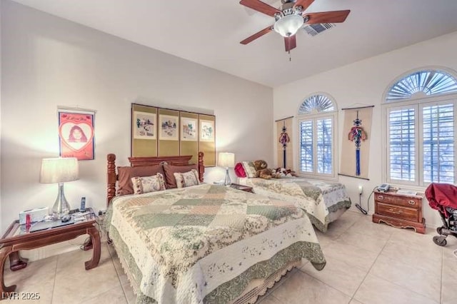 bedroom with light tile patterned floors, visible vents, and a ceiling fan