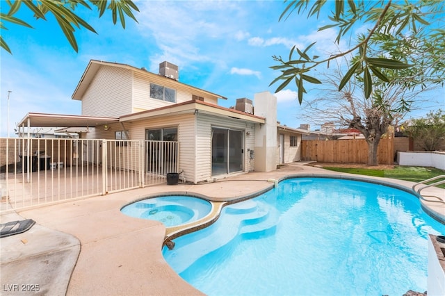 view of swimming pool featuring a patio, fence, a fenced in pool, and an in ground hot tub