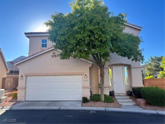 view of front of home featuring driveway, an attached garage, a tile roof, and stucco siding