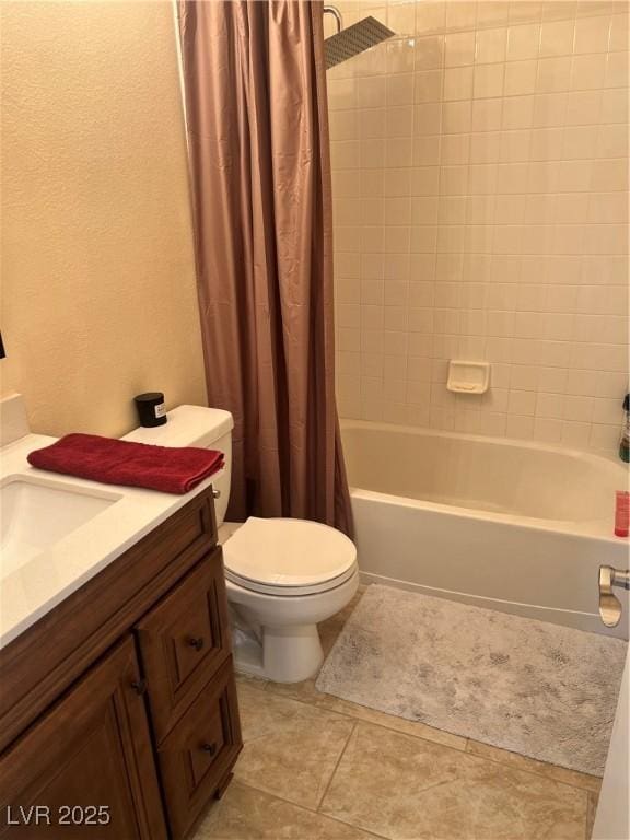 full bathroom featuring toilet, tile patterned floors, shower / bath combo with shower curtain, and vanity