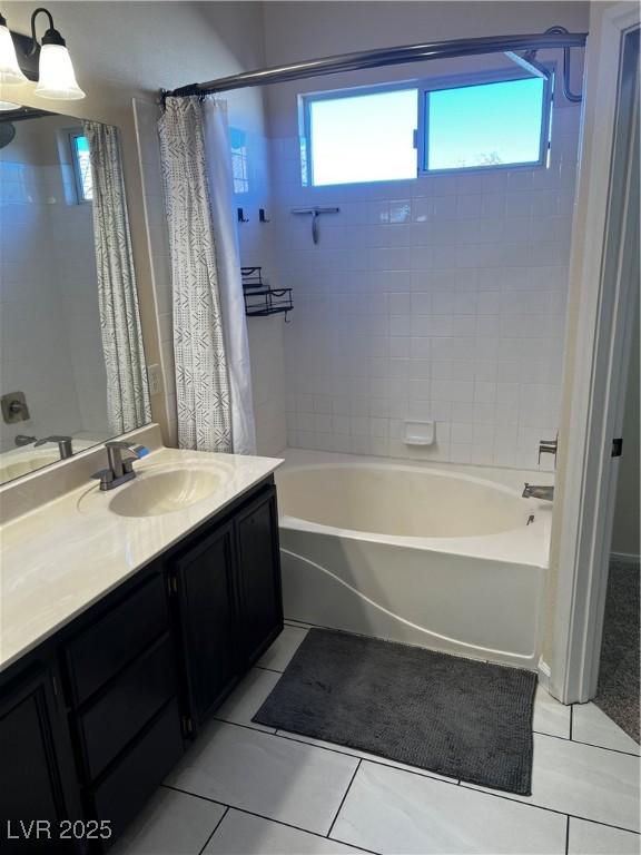 bathroom with shower / bath combo, vanity, and tile patterned floors