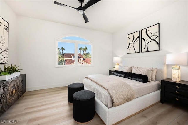 bedroom featuring ceiling fan, baseboards, and wood finished floors