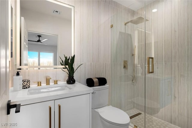 bathroom with tile walls, visible vents, and a stall shower