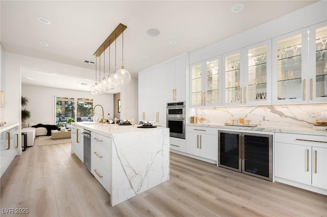 kitchen featuring wine cooler, decorative backsplash, stainless steel double oven, white cabinetry, and modern cabinets