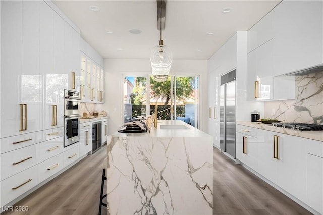 kitchen with wine cooler, white cabinets, modern cabinets, and backsplash