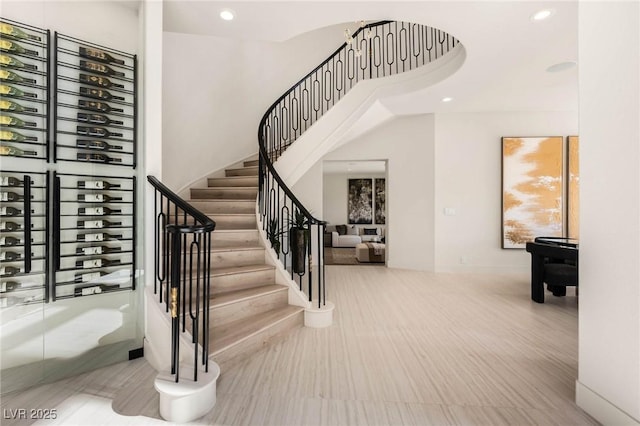 stairway with recessed lighting and a high ceiling