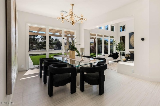 dining room featuring a notable chandelier, a healthy amount of sunlight, a high ceiling, and visible vents