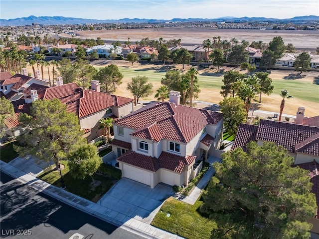 aerial view with a mountain view, golf course view, and a residential view