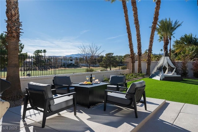 view of patio with a fenced backyard and a mountain view