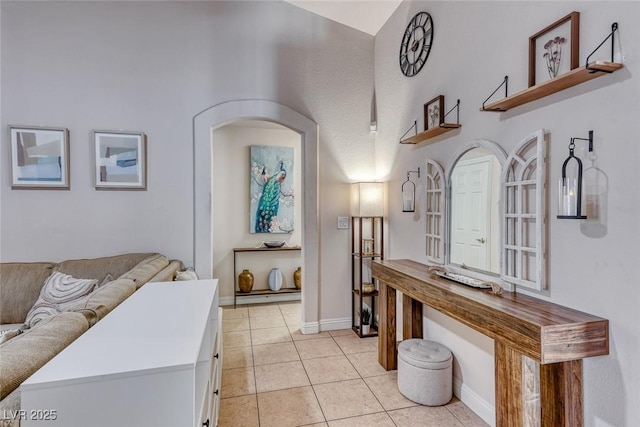 hallway with light tile patterned floors and baseboards