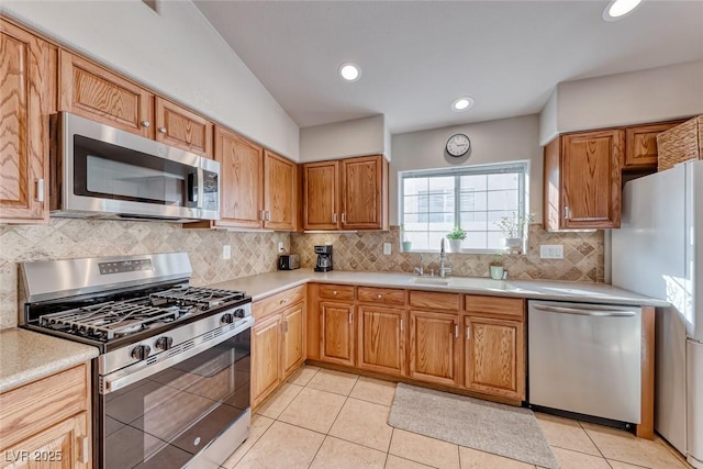 kitchen with light tile patterned floors, decorative backsplash, appliances with stainless steel finishes, light countertops, and recessed lighting