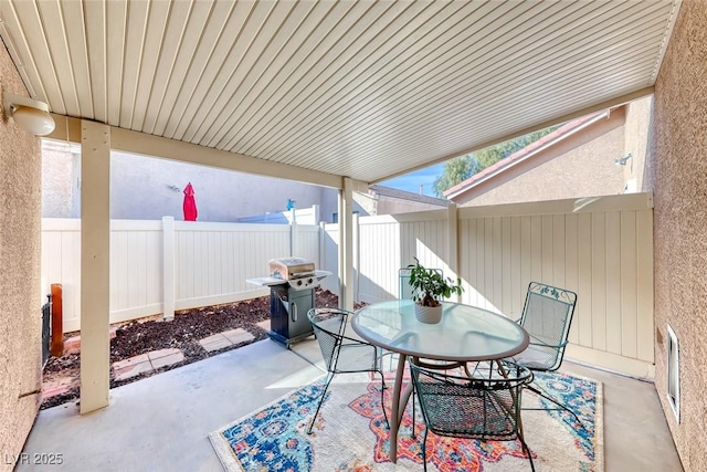 view of patio / terrace featuring outdoor dining space, a fenced backyard, and a grill