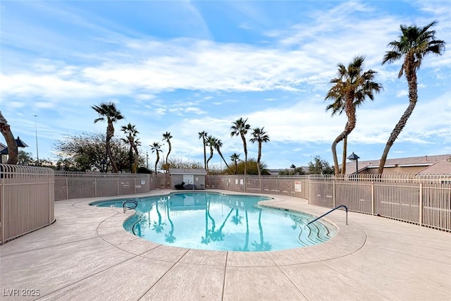 community pool featuring a patio and fence