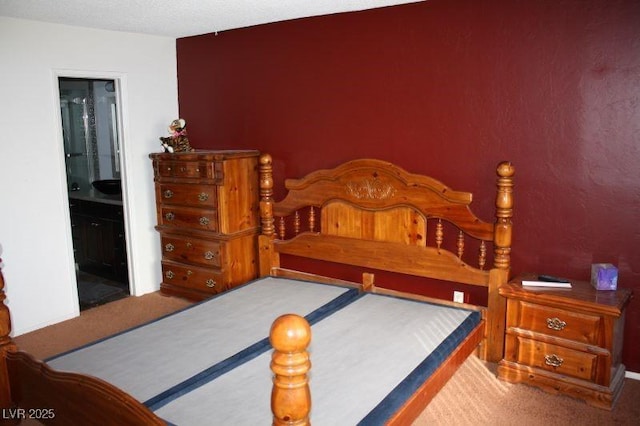 bedroom with carpet floors and ensuite bath