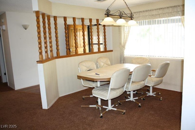 dining area with visible vents and dark colored carpet