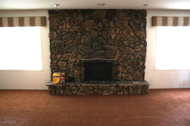 interior details with carpet floors, a fireplace, and a textured ceiling