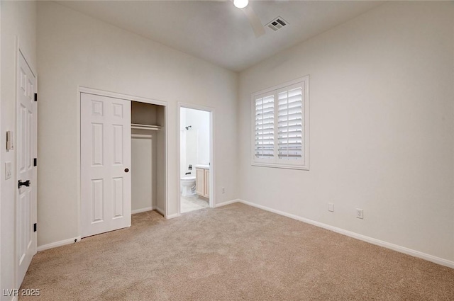 unfurnished bedroom featuring light carpet, ensuite bath, visible vents, and baseboards