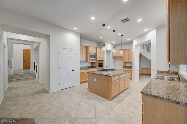 kitchen with recessed lighting, stainless steel appliances, visible vents, a center island, and decorative light fixtures