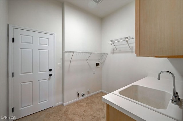 clothes washing area featuring light tile patterned flooring, hookup for a gas dryer, washer hookup, a sink, and cabinet space