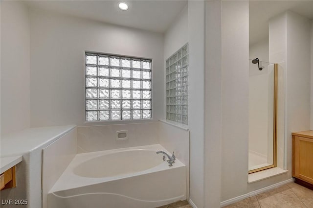 full bath with a stall shower, tile patterned floors, a garden tub, vanity, and recessed lighting