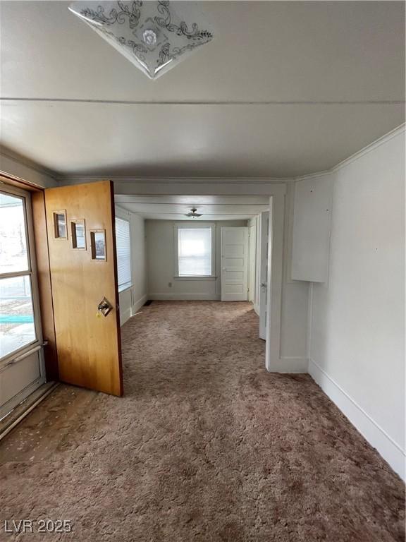 spare room with carpet flooring and baseboards