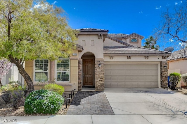 mediterranean / spanish home with a garage, concrete driveway, stone siding, and stucco siding