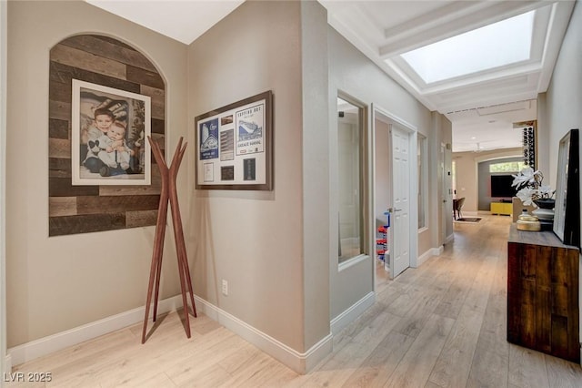 hall with light wood-type flooring and baseboards