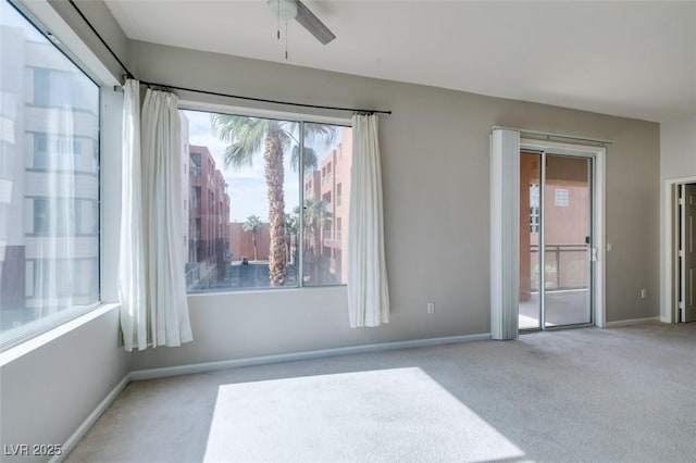 unfurnished room with light carpet, ceiling fan, and baseboards