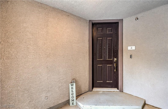 entrance to property with stucco siding