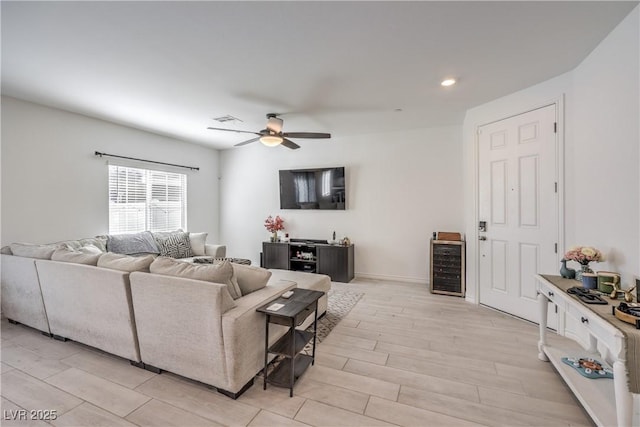 living room with wine cooler, light wood finished floors, recessed lighting, visible vents, and ceiling fan