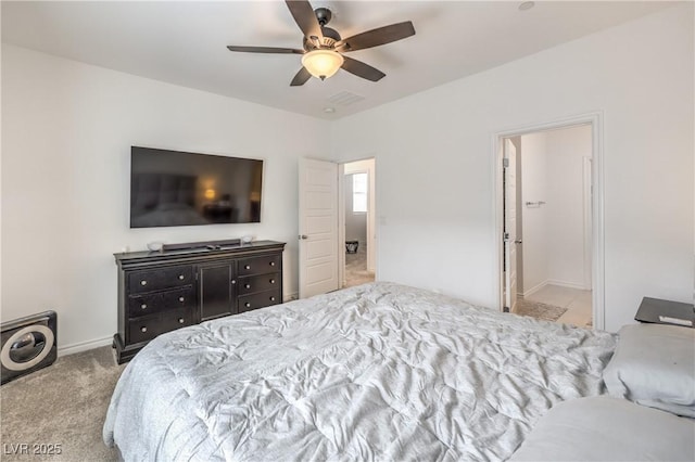 carpeted bedroom featuring baseboards and a ceiling fan