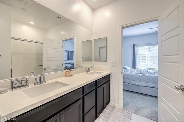 ensuite bathroom featuring visible vents, connected bathroom, a sink, and double vanity