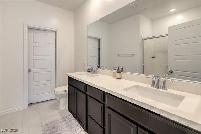 bathroom featuring a sink, a shower stall, toilet, and tile patterned floors