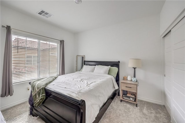 carpeted bedroom with baseboards and visible vents