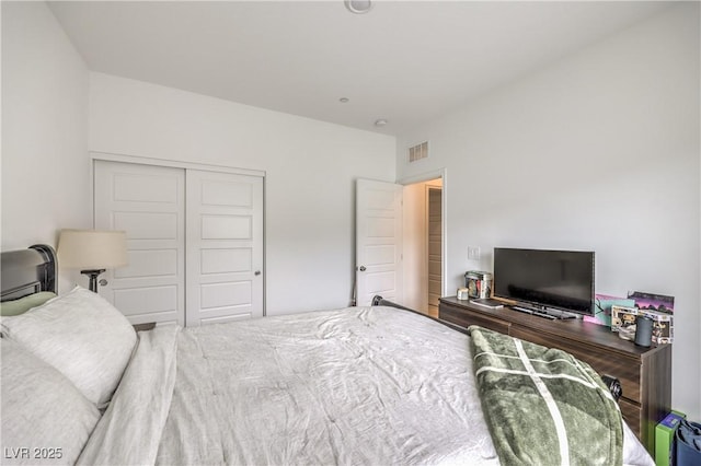 bedroom featuring visible vents and a closet