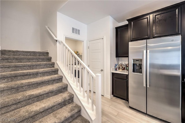 stairs featuring visible vents and wood finished floors