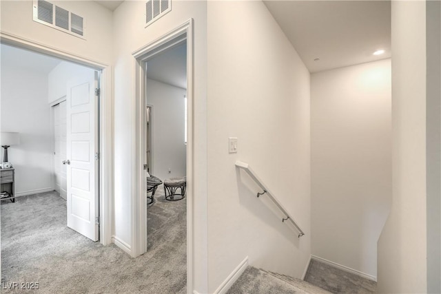 stairway featuring carpet, visible vents, and baseboards