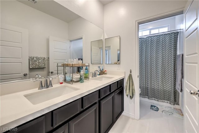 full bath with tile patterned floors, a sink, a shower with shower curtain, and double vanity